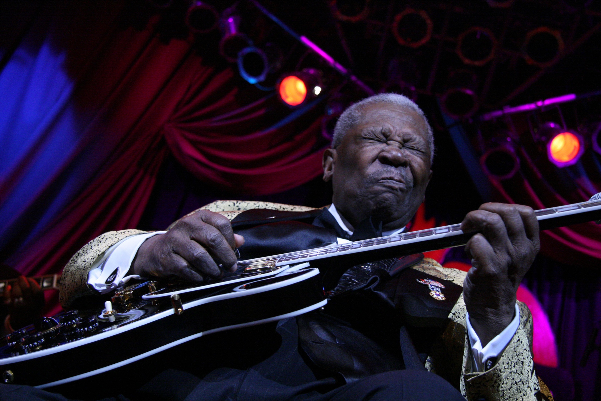 B.B. King performing onstage with his guitar