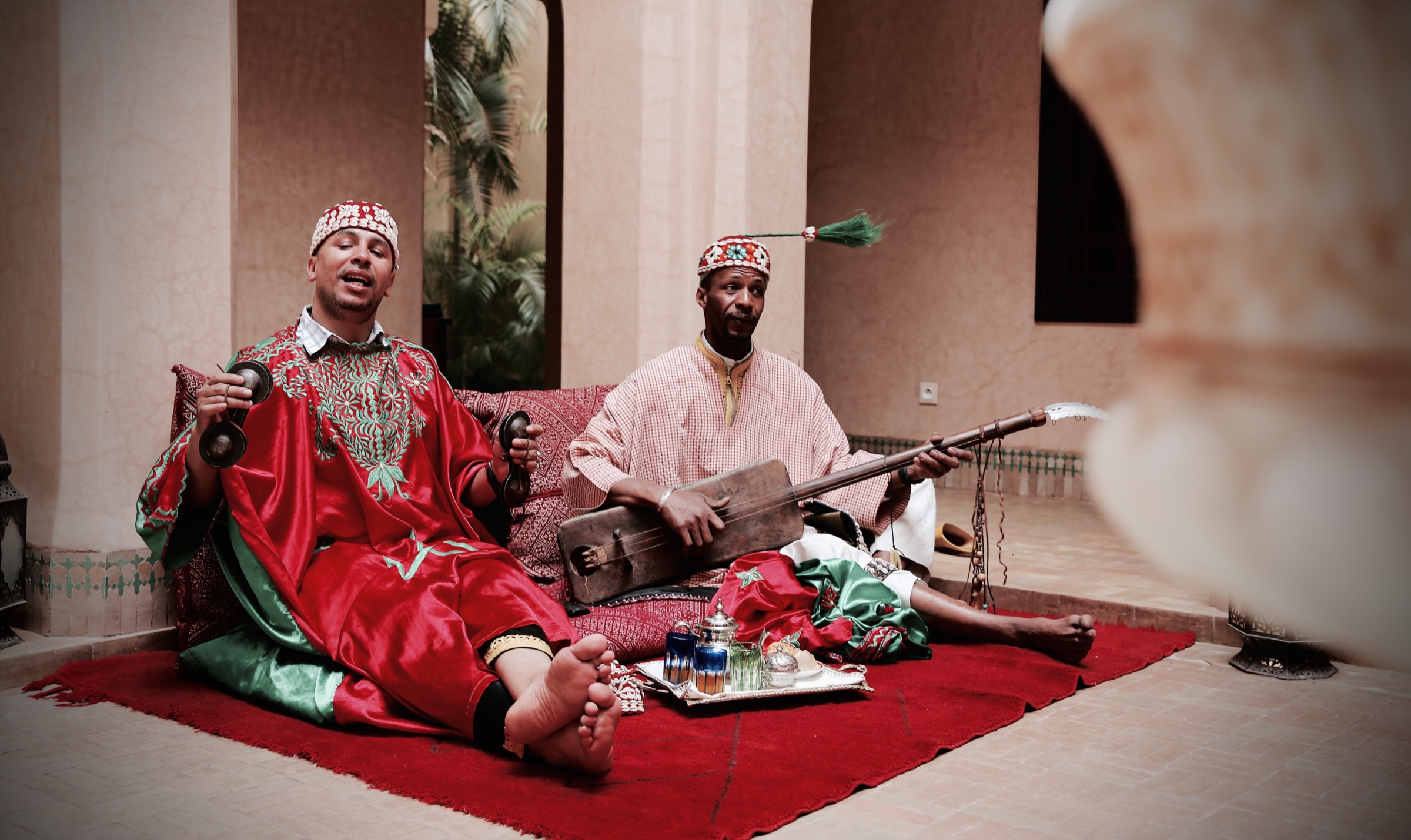 Two traditional musicians performing together in Morocco